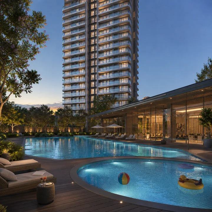Mahindra Navrat Sadahalli swimming pool and sun deck with the clubhouse frontage and tower line behind Mahindra Navrat Sadahalli swimming pool and sun deck with the clubhouse frontage and tower line behind